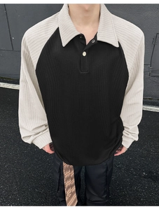 Detail of loose-fit polo collar sweatshirt with vertical ribbed contrast raglan sleeves