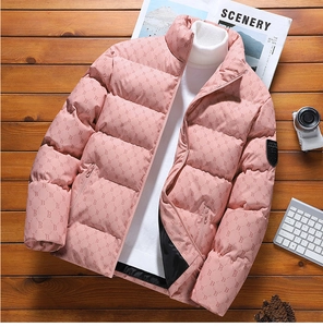 Detail of pink winter puffer jacket featuring letter B pattern on textured wood background