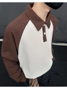 Detail shot of men's polo shirt showing premium textured fabric and raglan sleeve design