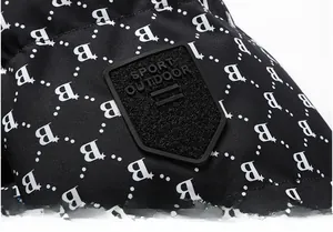Close-up of winter jacket fabric with white letter B print and rubber sport outdoor patch