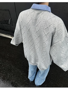 Rear view of grey cable-knit sweater with plaid shirt collar and casual blue jeans