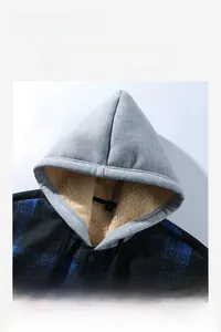 Detail of blue plaid hoodie featuring thick white fleece lining and soft thermal texture