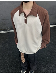 Close-up detail of the ribbed texture and contrast collar on the men's polo sweatshirt