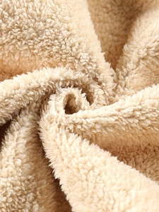 Close-up of thick beige polar fleece fabric for winter hooded jacket warmth