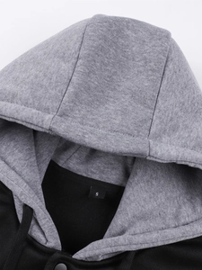 Detail of grey and black hooded jacket featuring knit texture and size S label