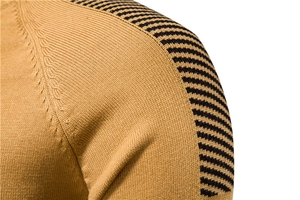 Detail shot of men's mustard knit sweater featuring black striped shoulder panels