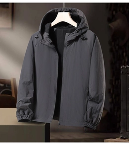 Detail of hooded sports jacket showing dark grey fabric and breathable mesh lining