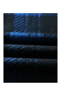Macro shot of heavy blue and black plaid fabric texture with a soft brushed fleece finish