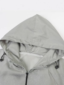 Light gray breathable hooded outdoor jacket with laser cut ventilation holes and mesh lining