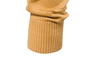 Close-up of camel knit sweater sleeve showing ribbed cuff detail and fabric texture
