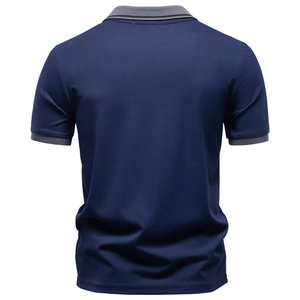 Close-up back view of navy blue polo shirt featuring grey striped collar and sleeve cuffs