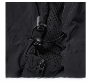 Detail of nylon jacket with adjustable drawstring, metal eyelet, and breathable mesh lining