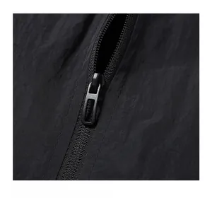 Detailed close-up of matte black metal zipper and tear-resistant nylon jacket fabric