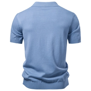 Detail view of light blue knit Polo shirt showing ribbed cuffs and precise back stitching
