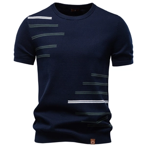 Detail of navy blue cotton knitted tee with white and green stripes on shoulder and hem