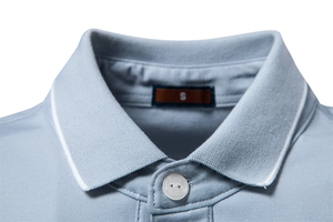 Detail of light blue men's polo collar with white contrast stripes and dense stitching