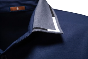 Detailed close-up of dark blue Polo shirt collar with jacquard knit and leather size label