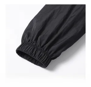 Detail of elastic cuffs on a black nylon windbreaker jacket with premium stitching