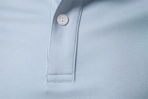 Detail of light blue Polo shirt placket showing pique knit fabric and white button