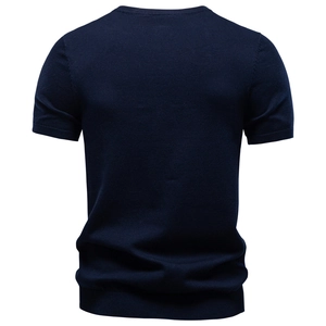 Rear view detail of dark blue cotton knit t-shirt showing fine texture and hem stitching