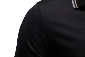 Detail of black polo shirt collar with elegant grey, beige and navy blue striped trim