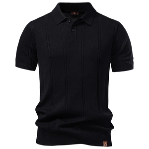 Close-up of black knit Polo shirt detailing vertical jacquard stripes and leather hem tag