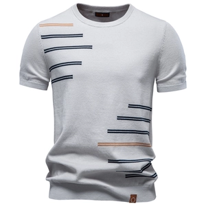 Close-up of crew neck knit T-shirt with navy and yellow stripes on light grey cotton
