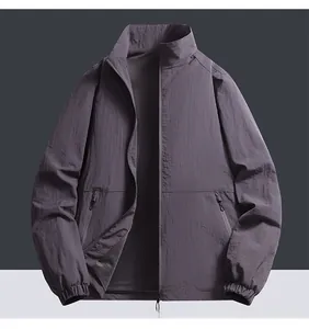 Detail of grey bomber jacket showing mesh lining, stand collar, and zipper pockets