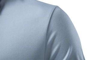 Close-up of the breathable honeycomb texture and shoulder seam on this blue polo shirt