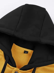 Detail shot of the black and ginger hoodie hood with drawstring and S size tag