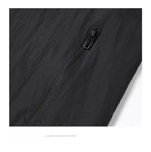 Macro shot of durable nylon fabric texture and matte black zipper detail on a hooded jacket