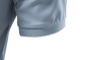 Detailed close-up of ribbed cuffs and breathable pique mesh fabric on a grey Polo shirt