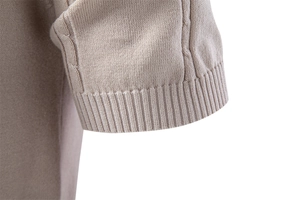 Detailed close-up of ribbed cuffs and twisted cable knit texture on men polo shirt