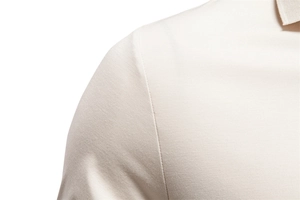 Close-up detail of beige Tencel polo shirt shoulder seam and fine knit fabric texture