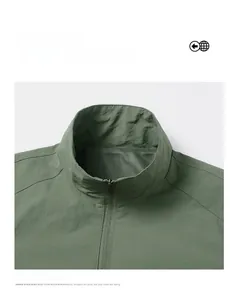 Detail of dark green bomber jacket collar with breathable mesh lining and metallic zipper