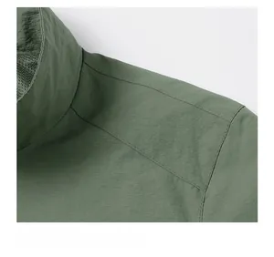Detail view of the stitching and collar on this dark green bomber jacket for men