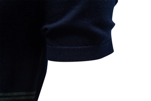 Detail view of navy blue cotton knitted t-shirt showing the ribbed cuff and fabric texture