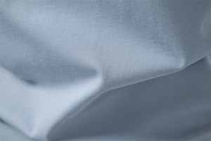 Macro shot of premium light blue Tencel polo shirt fabric showing fine twill texture