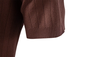 Macro detail of dark brown knit polo sleeve showing vertical texture and ribbed cuff