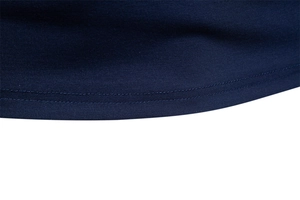Close-up of navy blue Tencel polo shirt hem featuring precise double-needle stitching detail