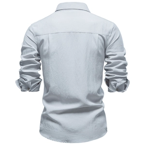 Detailed back view of light blue wrinkled fabric shirt with seams and textured linen material