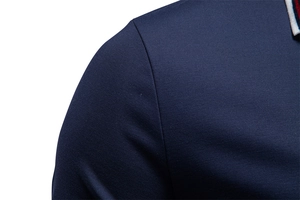 Close-up of navy blue polo shirt shoulder with tricolor striped collar detail