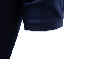 Detailed macro view of navy blue Polo shirt sleeve with ribbed cuff and white stripes