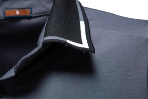 Close-up of polo shirt collar with striped ribbing and textured dark grey pique fabric