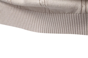 Detailed close-up of vertical knit texture and ribbed hem on beige business polo shirt