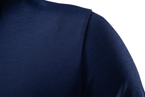 Macro detail showing the shoulder stitching and twill texture of a navy blue polo shirt