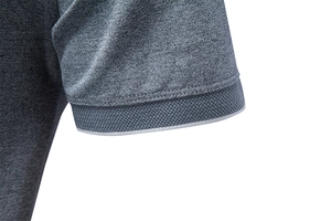 Detailed macro view of the breathable heather grey honeycomb knit texture and ribbed cuff
