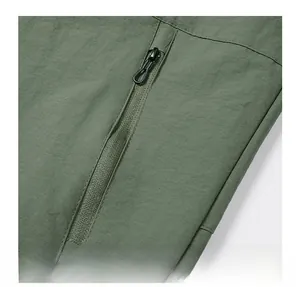 Detailed macro shot of an olive green bomber jacket pocket with a black rope pull zipper