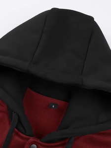 Detail shot of the red and black hoodie collar with size label S and woven drawstrings