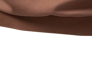 Detailed macro view of the brown polo shirt ribbed hem and smooth knitted fabric texture